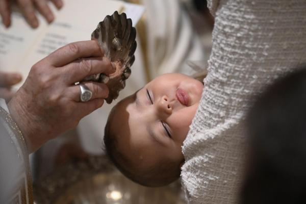 Pope Francis baptizes an infant