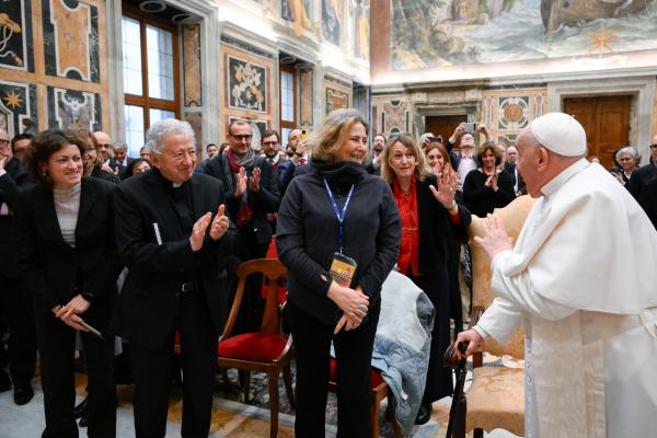 Pope Francis greets journalists. 