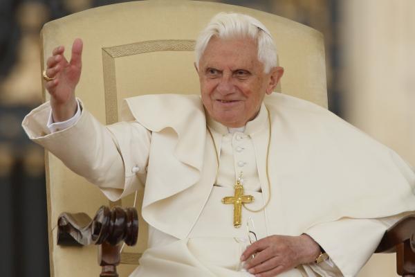 Pope Benedict XVI waves.