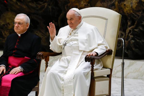 Pope Francis waves at his general audience