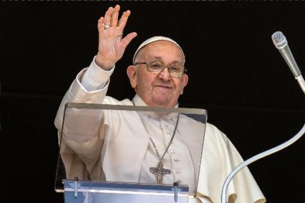 Pope Francis waves to visitors in St. Peter's Square