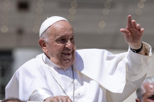 Pope Francis waves to visitors.