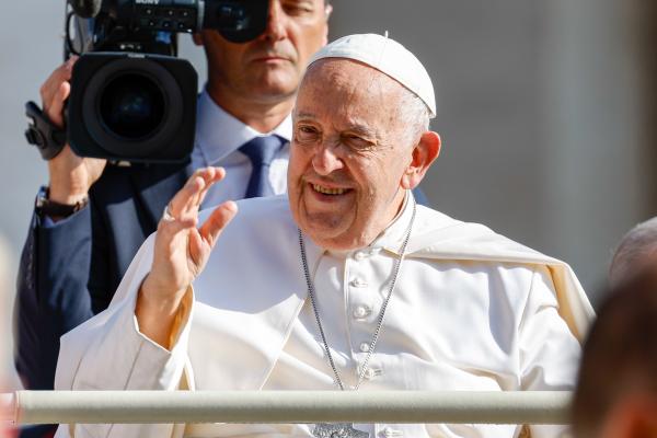 Pope Francis rides the popemobile in St. Peter's Square.