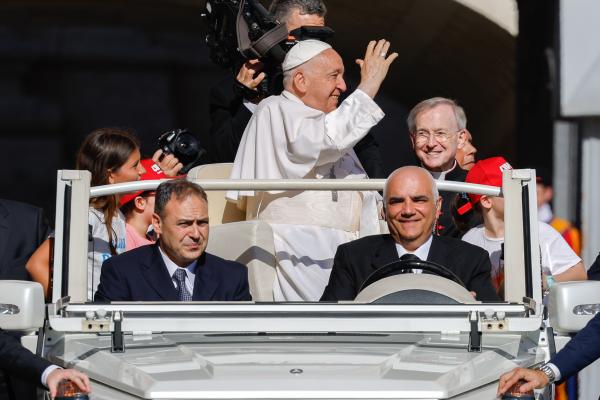Pope Francis waves to visitors from the popemobile.