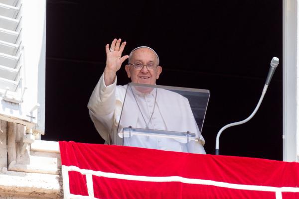 Pope Francis waves to visitors in St. Peter's Square