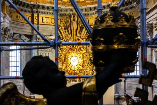 A statue of a cherub holds the papal tiara.