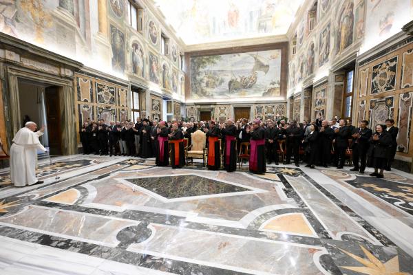 Pope Francis greets participants in a conference on martyrdom.