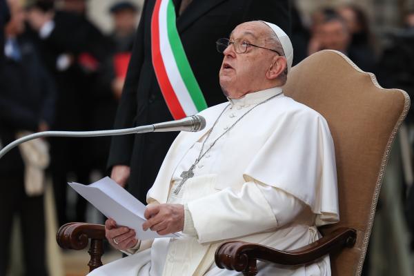 Pope Francis looks up at a statue of Mary