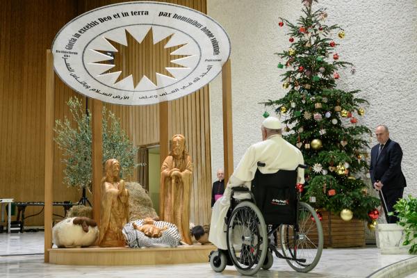 Pope Francis prays before the Bethlehem Nativity scene