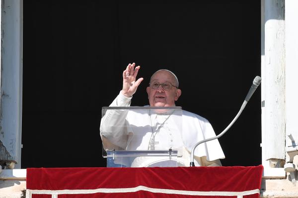 Pope Francis greets visitors in St. Peter's Square gathered to pray the Angelus.