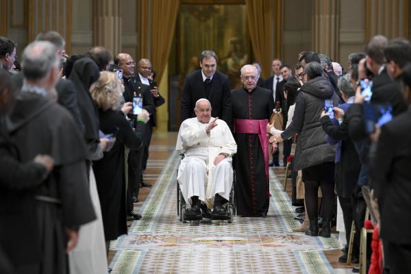 Pope Francis greets participants in a theology conference.