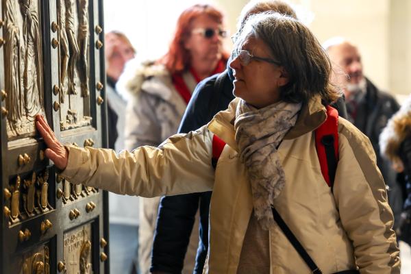 A visitor touches the Holy Door of St. Peter’s Basilica on Christmas Day, Dec. 25, 2024.
