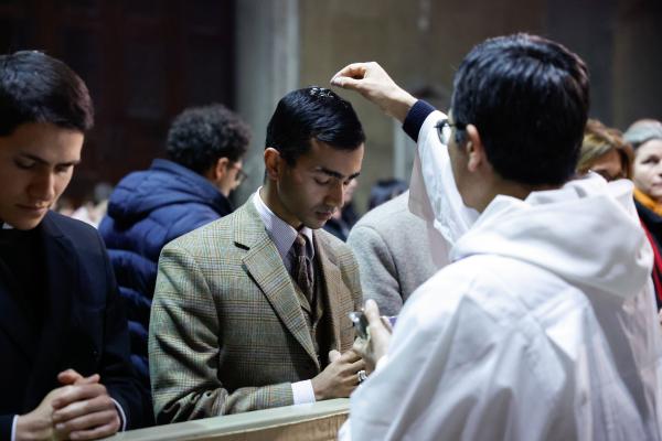 A man receives ashes during Pope Francis' Ash Wednesday Mass.