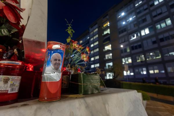 Candles with Pope Francis' photo are outside Rome hospital