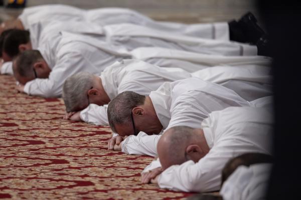 Deacons lie prostrate during ordination Mass.