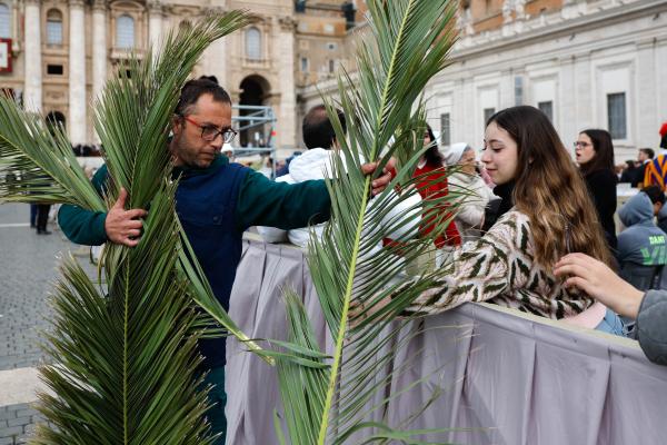 Handing out palms before Palm Sunday Mass at the Vatican last year