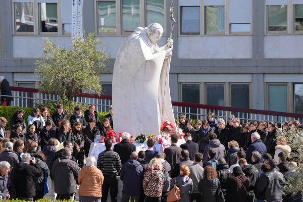 People pray for Pope Francis outside the Gemelli hospital