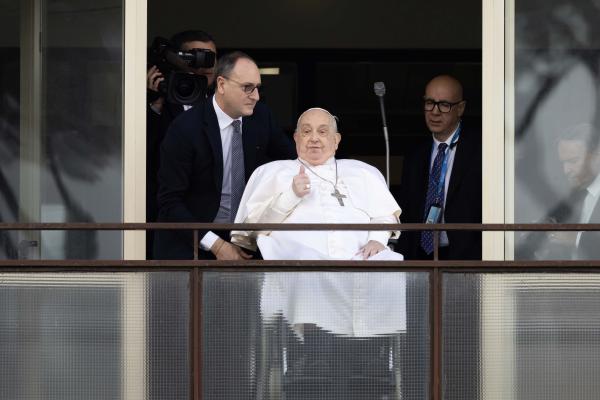 Pope Francis gives a thumbs up to the crowd at Gemelli hospital