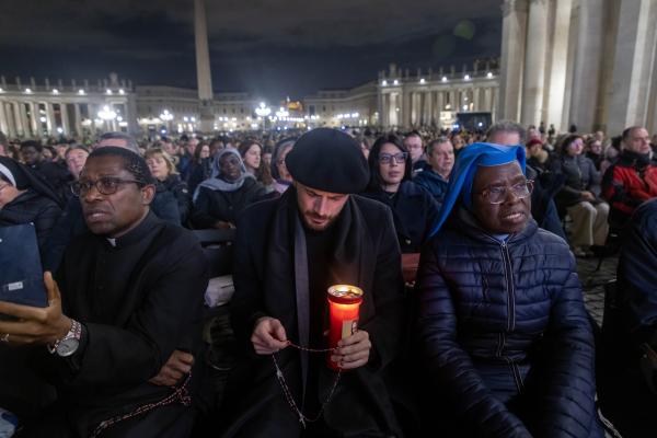 People join Cardinal Víctor Manuel Fernández, prefect of the Dicastery for the Doctrine of the Faith, for the recitation of the rosary for Pope Francis in St. Peter’s Square.