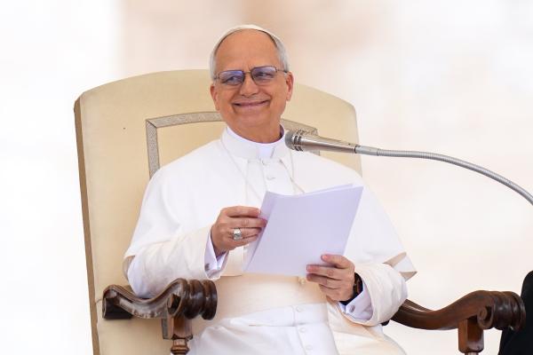 Pope Leo XIV smiles during his first general audience
