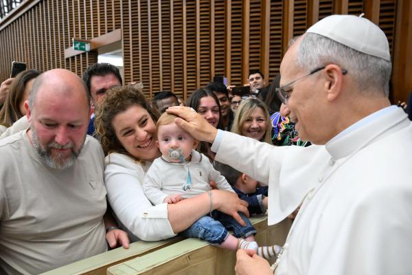 Pope Leo XIV greets the child of a Vatican employee