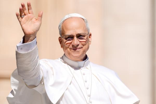 Pope Leo XIV waves from the popemobile