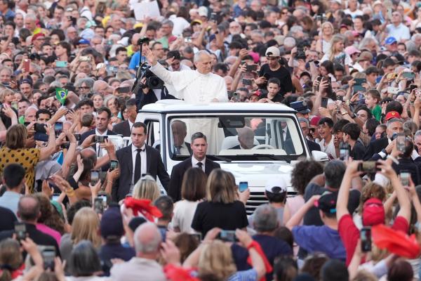 Pope Leo XIV rides in the popemobile before a prayer vigil