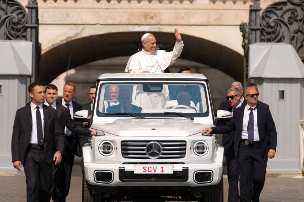 Pope Leo XIV waves from the popemobile
