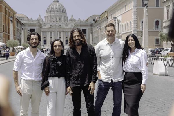 Members of the cast and crew of the series, "The Chosen," pose for a picture in front of St. Peter's Basilica.