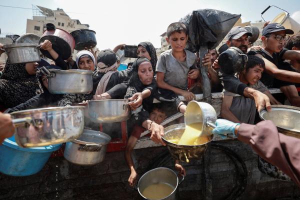 Palestinians receive food from charity kitchen in Gaza