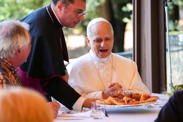 Pope Leo XIV reacts as lunch is served