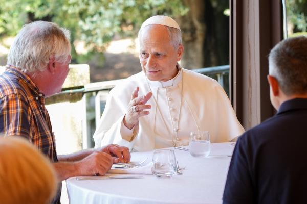 Pope Leo XIV speaks to his lunch guests