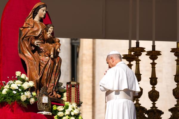 Pope Leo XIV prays in front of a statue of Mary