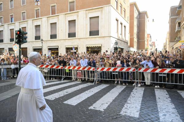 Pope Leo greets people outside the St. Anne's Gate at the Vatican
