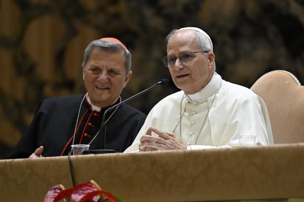 Pope Leo answers questions while Cardinal Grech looks on