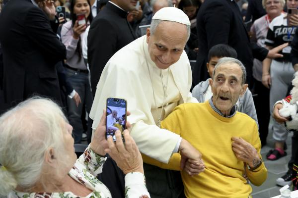 Pope Leo poses for a photo with a lunch guest