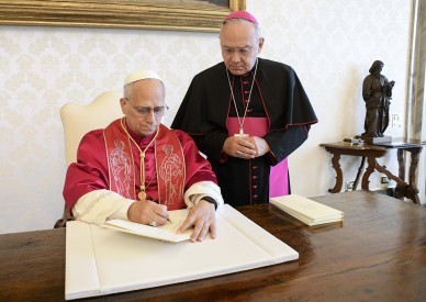 One can't serve God and money, pope says on day he signs text on poverty