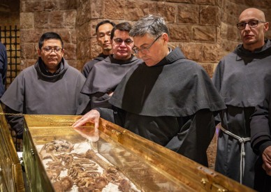 Why do the bones of St. Francis draw hundreds of thousands of pilgrims?