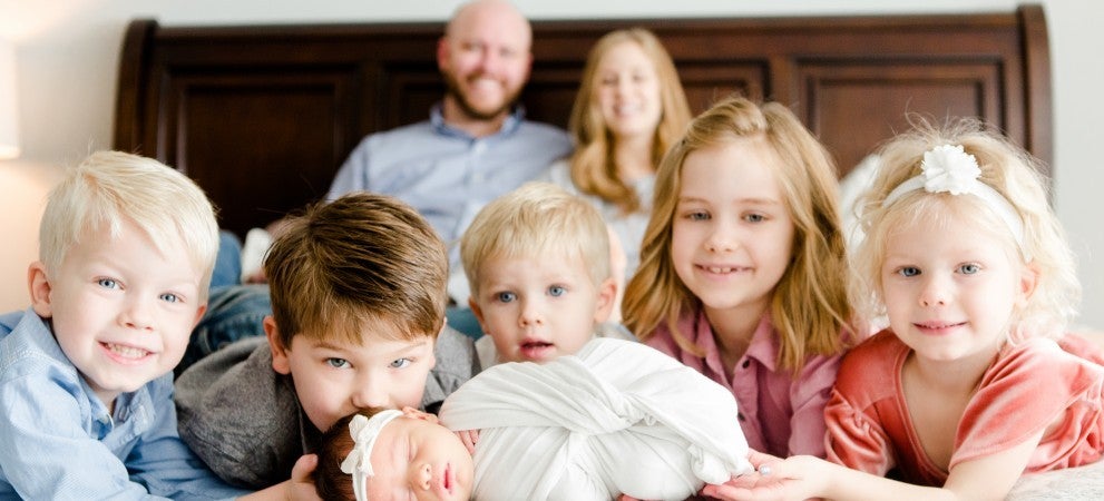 Family with Six  children with Baby in front and Parents in back 