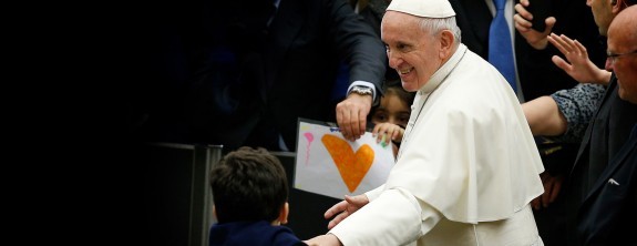 Pope Francis greets a child at an audience.
