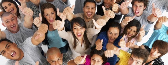a multicultural crowd of people cheering