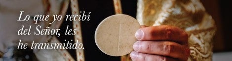 Priest holding a host with text from scripture