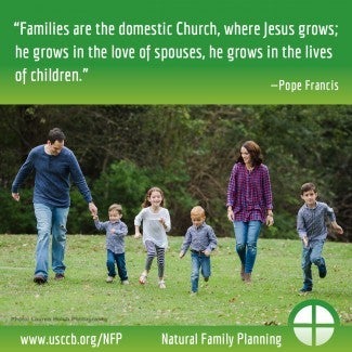 Family with four small children walking together