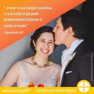 Bride smiles at camera, groom kisses her forehead
