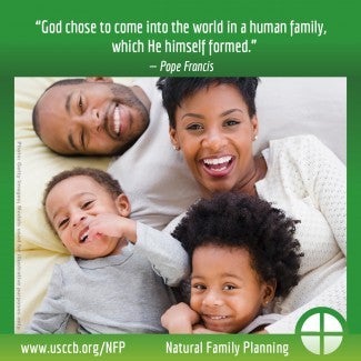 Family with two small children playing and smiling