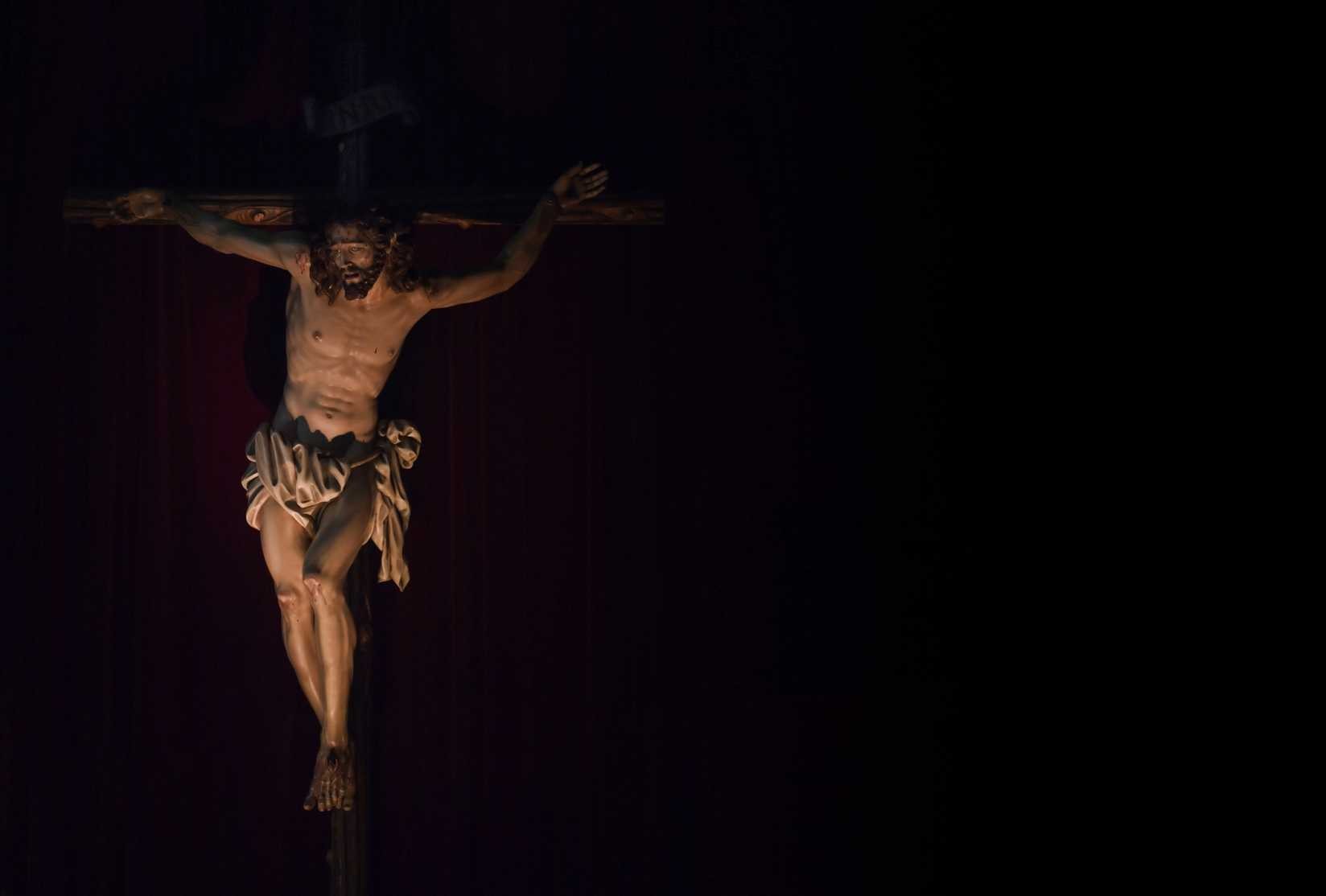 Figure of Jesus hanging on the cross with a black background