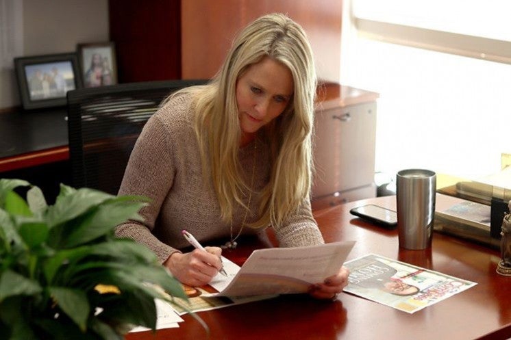 Editing a newspaper at a traditional office desk