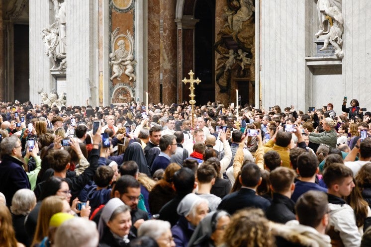 Altar servers process down the central nave of St. Peter's Basilica.