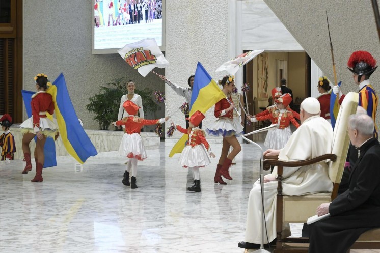 Pope Francis looks on as dancers perform.