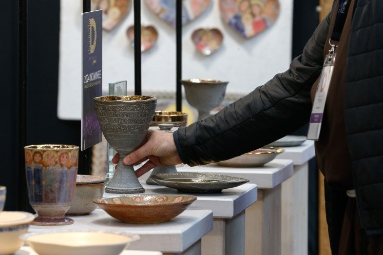 A shopper picks up a chalice.